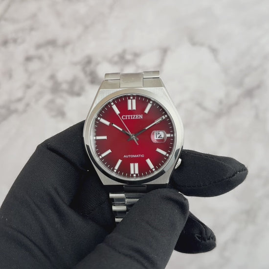 Citizen Tsuyosa NJ015 automatic watch with burgundy sunray dial, integrated stainless steel bracelet, sapphire crystal, and 40mm stainless steel case.