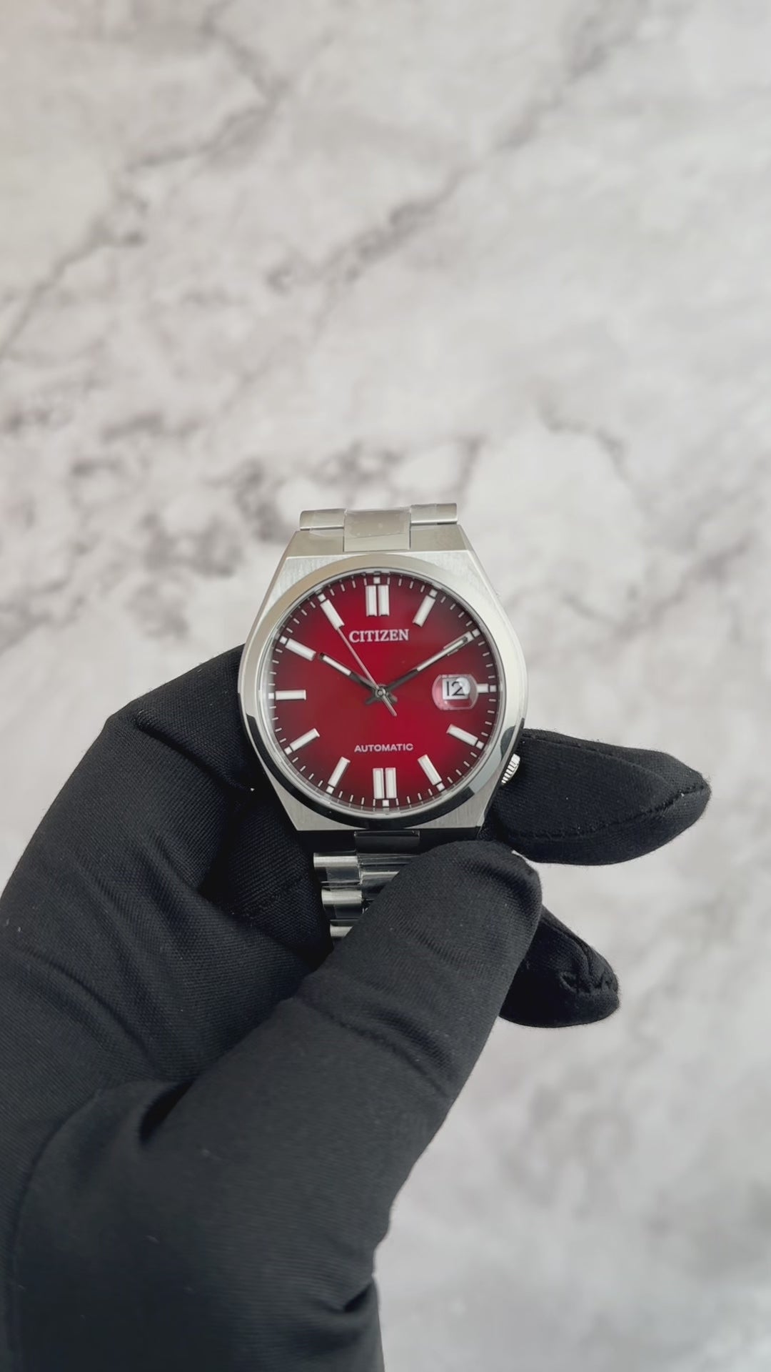Citizen Tsuyosa NJ015 automatic watch with burgundy sunray dial, integrated stainless steel bracelet, sapphire crystal, and 40mm stainless steel case.