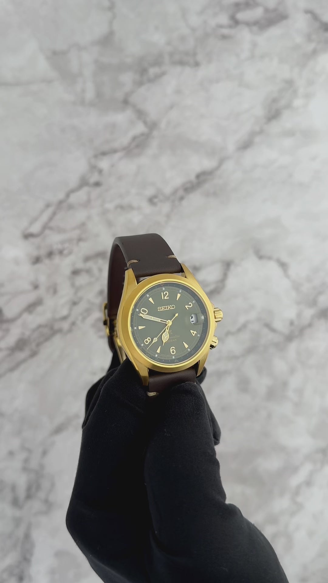SEIKO PROSPEX SPB210 Alpinist – vintage-inspired green dial with gold accents, inner compass bezel, gold-tone stainless steel case, brown leather strap, automatic movement, and 200m water resistance