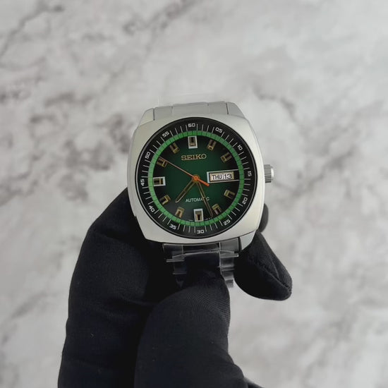 Seiko SNKM97 – bold retro-style automatic watch from the Recraft Series with green sunray dial, gold-tone accents, cushion-shaped stainless steel case, and see-through caseback.