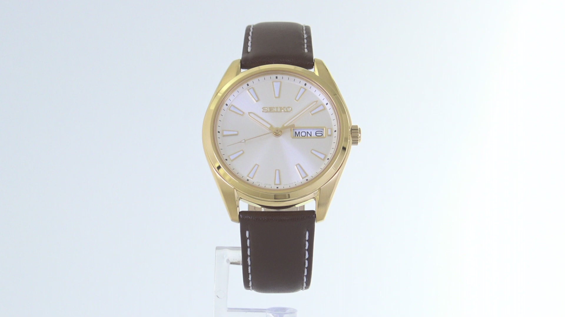Seiko Essentials SUR450 – elegant gold-tone men’s quartz watch with champagne dial, sapphire crystal, day/date window, and brown leather strap