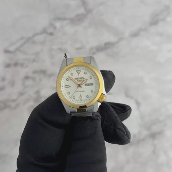 Seiko 5 Sports SRE004 automatic watch with white sunray dial, luminous hands and markers, two-tone stainless steel case and bracelet, and compact vintage-inspired design.
