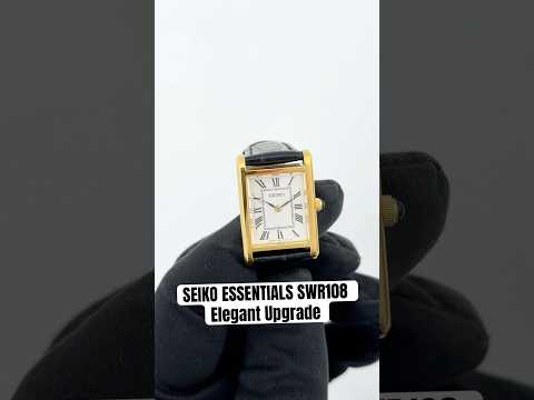 Seiko SWR108 women’s rectangular quartz watch with white Roman numeral dial, two-tone stainless steel case with gold accents, sapphire crystal, and black leather strap.