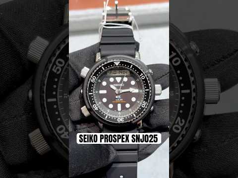 Seiko Prospex SNJ025 Solar Tuna analog-digital diver’s watch with black dial, LumiBrite hands and markers, shroud-style case, solar-powered H851 movement, one-way rotating bezel, and 200-meter ISO-certified water resistance.