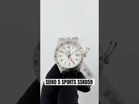 Seiko SSK059 Seiko 5 Sports Field GMT automatic watch with white dial, red-orange GMT hand, 24-hour bezel, stainless steel bracelet, and 39.4mm case.