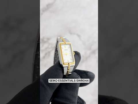 Seiko Essentials SWR044 women’s watch with slim rectangular two-tone stainless steel case and bracelet, white dial with gold-tone hands and markers, Hardlex crystal, quartz Caliber 4N30 movement, 30m water resistance, and ultra-thin 5.68 mm profile.